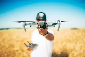 student pilot holding drone and remote control