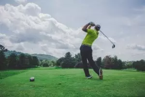 man swinging golf club on a beautiful day in Arizona