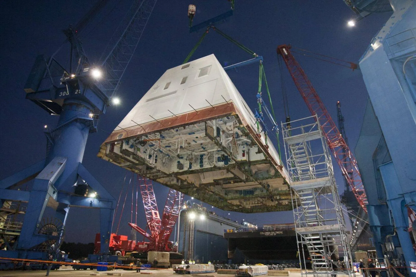 121214-N-ZZ999-201 (2012) The 1,000 ton deckhouse of a future destroyer is craned toward the deck of the ship to be integrated with the ship’s hull at General Dynamics Bath Iron Works. Photo by: U.S. Navy